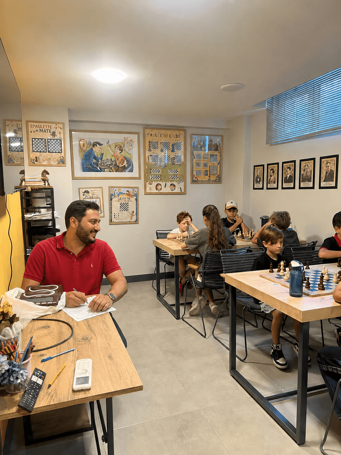 Emin reviewing a game with a small group of young students